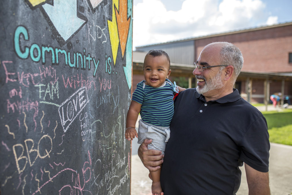 Father holding his child smiling