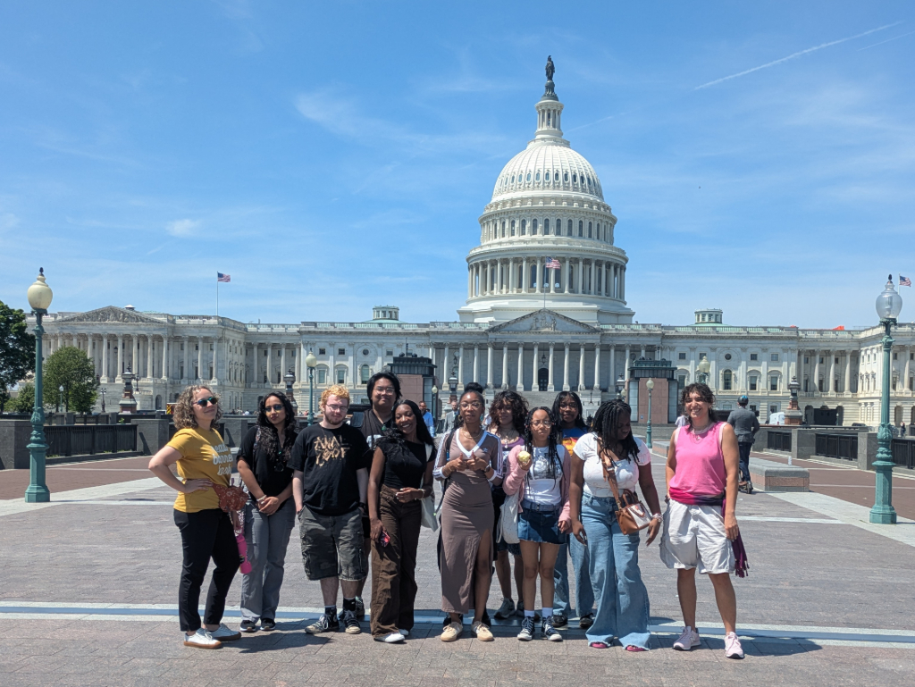 Eleven members of the Action Research Team youth and adults standing in front of the Capitol building in Washington DC.
